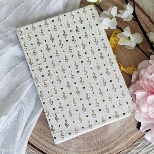 instagram-5 🎼Carnet à reliure copte modèle CLÉ DE SOL.
Carnet de note format A5 et comprenant 192 pages. 

⚘️Pour la couverture de ce carnet j'ai sélectionné un très beau papier italien aux motifs clé de sol en dorure. 

🌸La reliure copte est une couture visible faite à la main. Le carnet ne possède donc pas de dos mais cela permet une ouverture à plat.